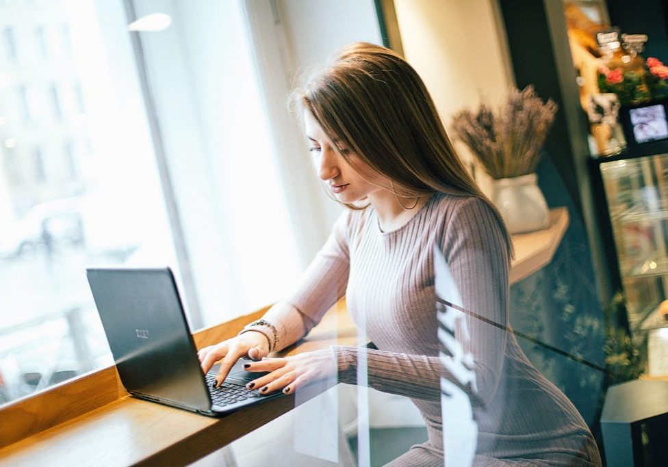 woman-in-white-long-sleeve-dress-using-laptop-computer