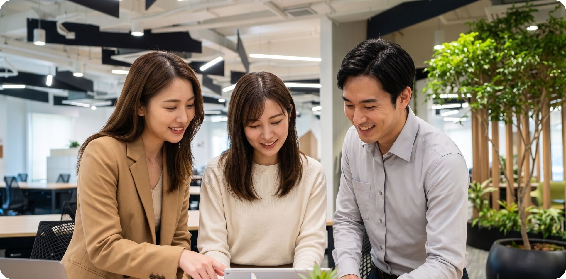 Colleagues collaborating around a laptop at Zero-Ten Park's BGC workspace