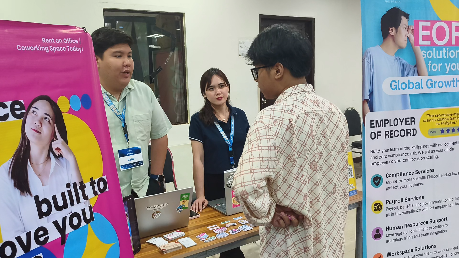 Lanz Christian Tan and Aprille Ann Famulagan answering questions at the Zero-Ten Park booth at AWS Community Day Cebu 2026