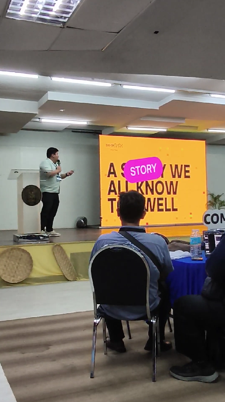 Lanz Christian Tan of Zero-Ten Park speaking on stage at AWS Community Day Cebu 2026