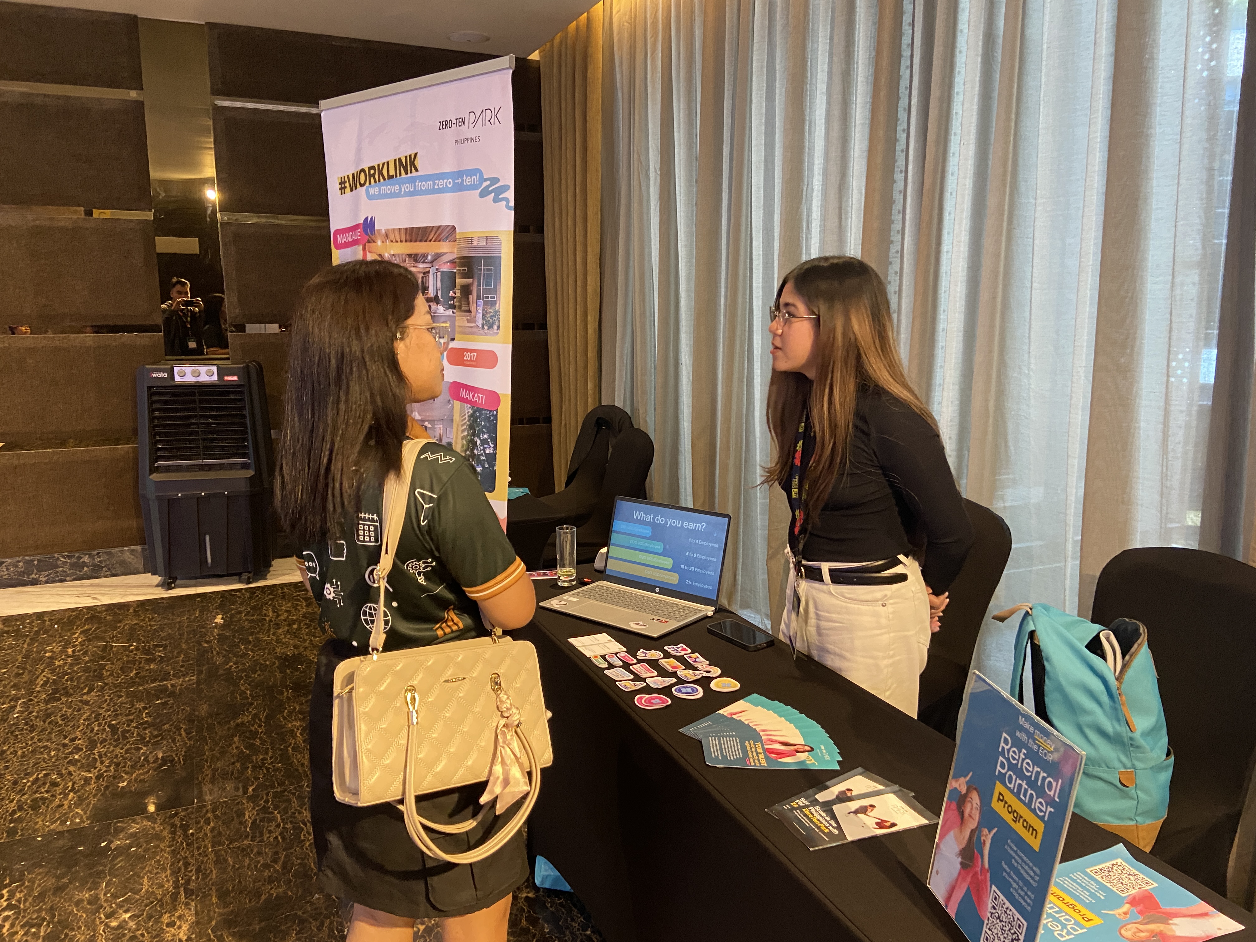 Bay from Zero-Ten Park talking to an interested visitor at the EOR booth, Cebu Summit 2026