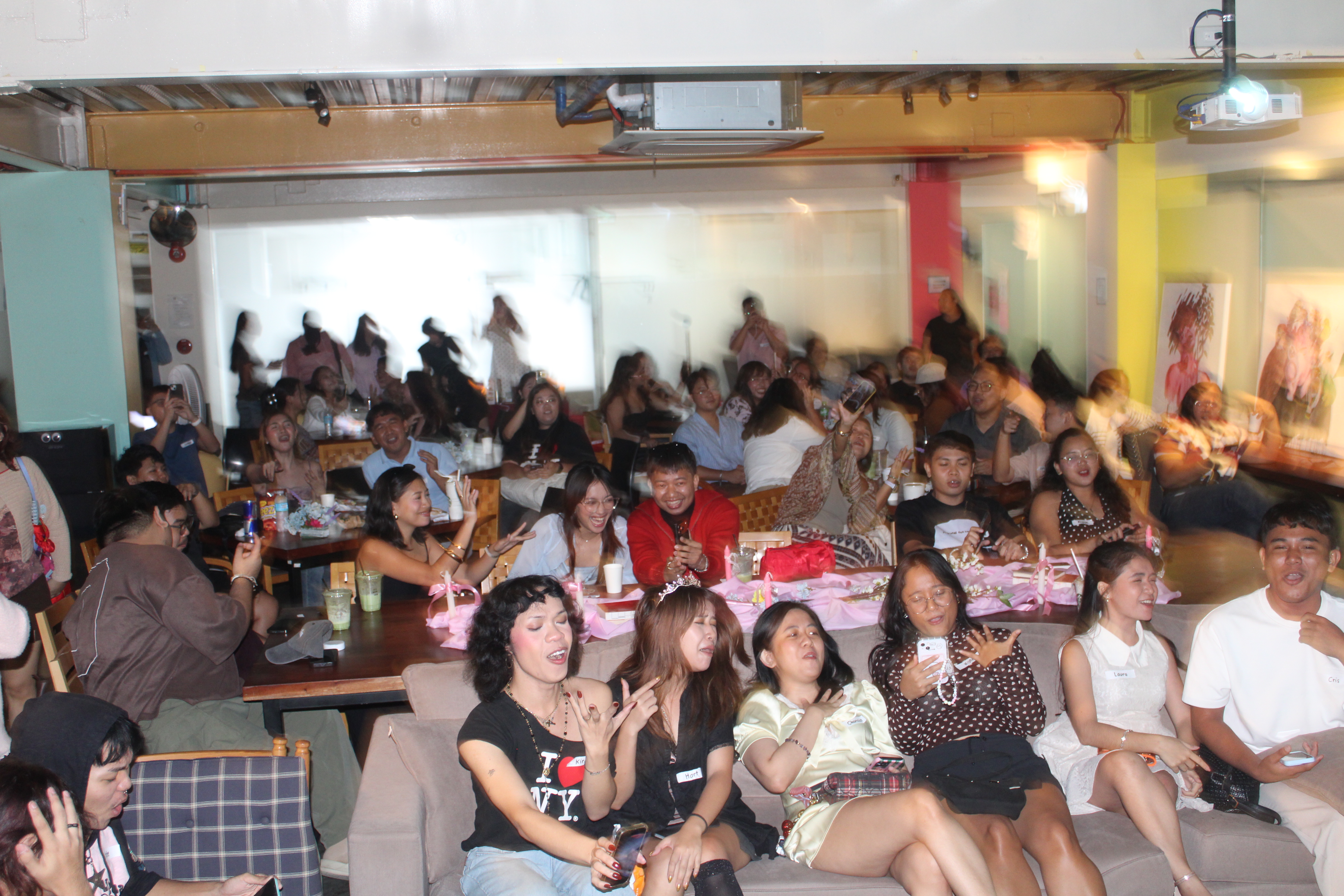 Crowd gathered at a co-working space in Cebu for the Olivia Rodrigo listening party at Zero-Ten Park Mandaue